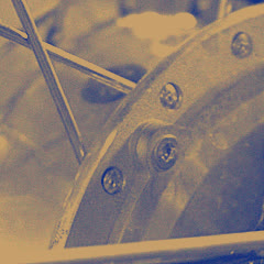 The polished shell of a hub, its bolts and spoke holes